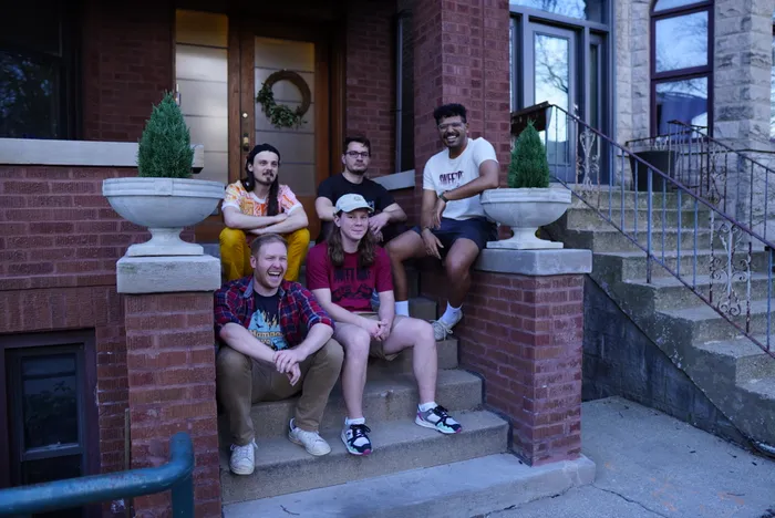 tenmonthsummer, the full band seated together on a set of front steps